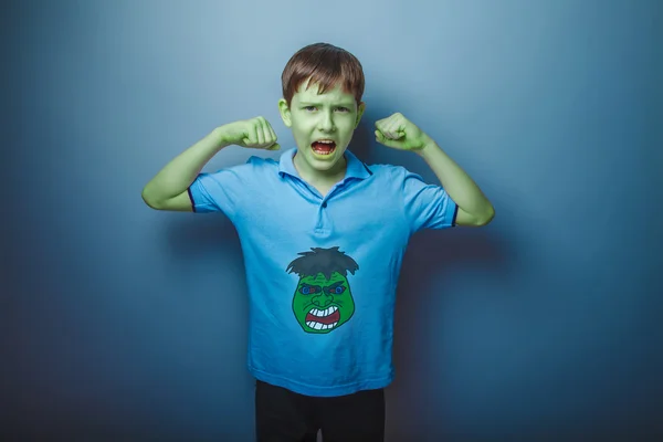 Green superhero teenage boy raised his hand shouting skin streng — Stock Photo, Image