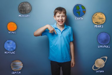 Boy laughing teenager shows his hand down the planet of the sola