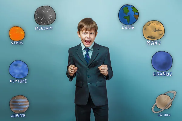 A teenager in a business style suit boy clenched his fists and s — Stock Photo, Image