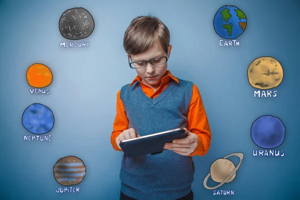 Adolescent boy with glasses working on a tablet of the planet of — 스톡 사진