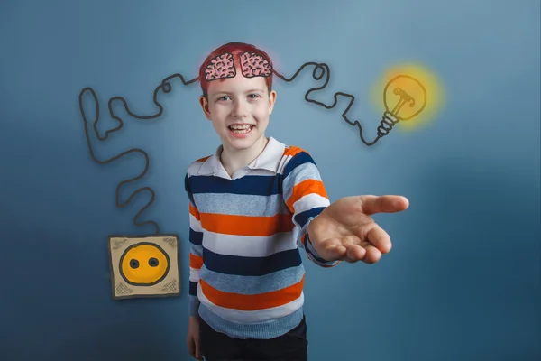 Teen boy laughs and reaches out charging cord plug wire igniter — Stock fotografie