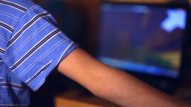 Teenage boy playing close-up computer game video sitting back room evening — Stock Video