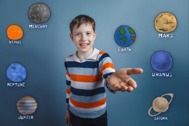 Teen boy smiles and holds out his hand toward a joyful gesture o