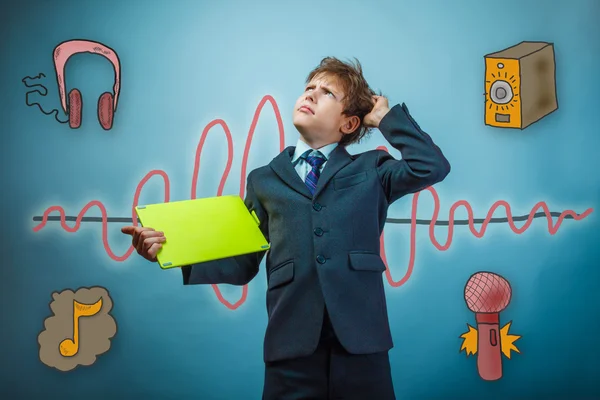 Boy in a business style suit teenage scratching his head and loo — Zdjęcie stockowe