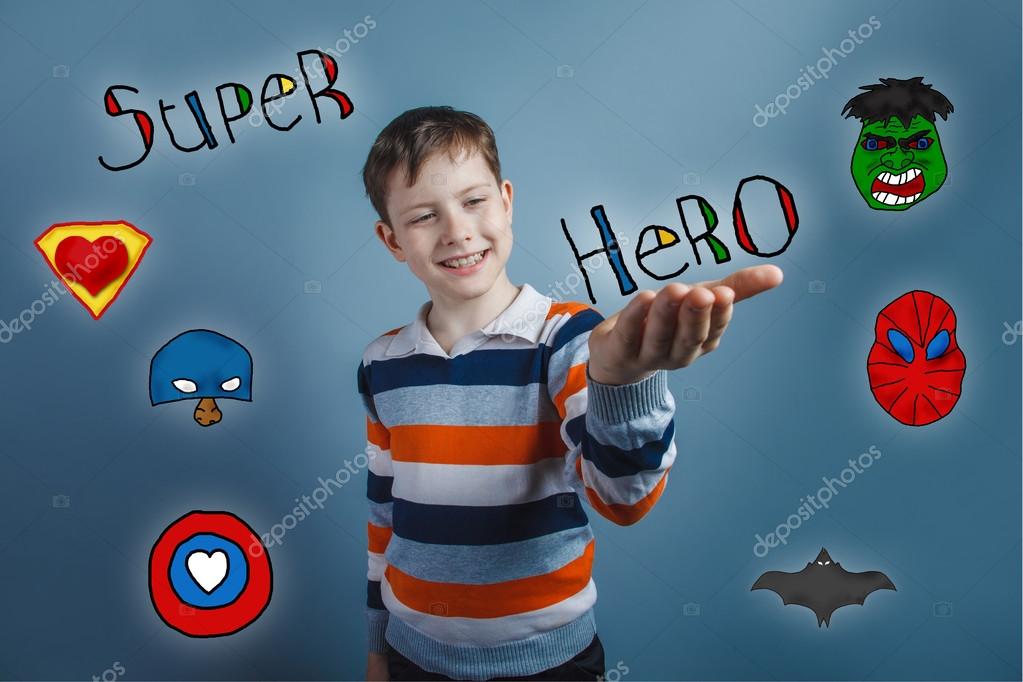 Boy smiling and holding his hand on the word superhero super power at the photo studio Icons hero