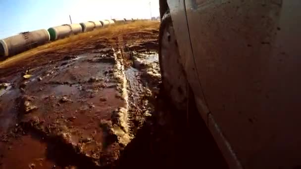 Auto voiture à travers va flaques et boue soleil éblouissement sur l'eau — Video