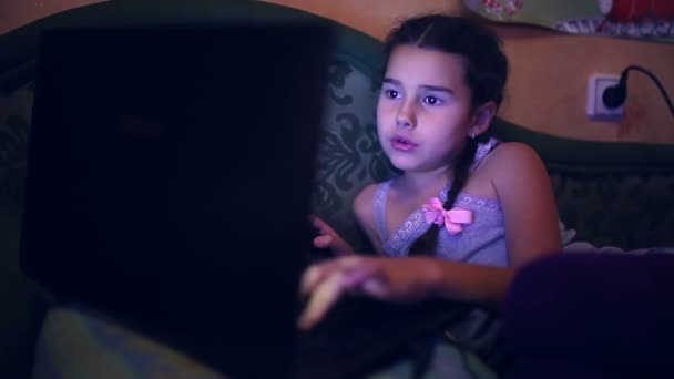 ソファのコンピュータゲームのインターネット検索に横たわってラップトップ十代の女の子を再生 — ストック動画