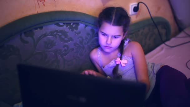 Girl teen playing laptop  lying on the sofa internet search computer game — Stock Video
