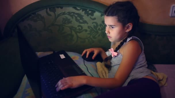 Girl teen playing  laptop  lying on the sofa internet search computer game lifestyle — Stock Video