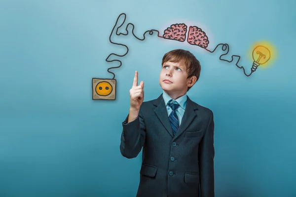 Teenage boy in suit raised his index finger up charging cord plu — Stock Photo, Image