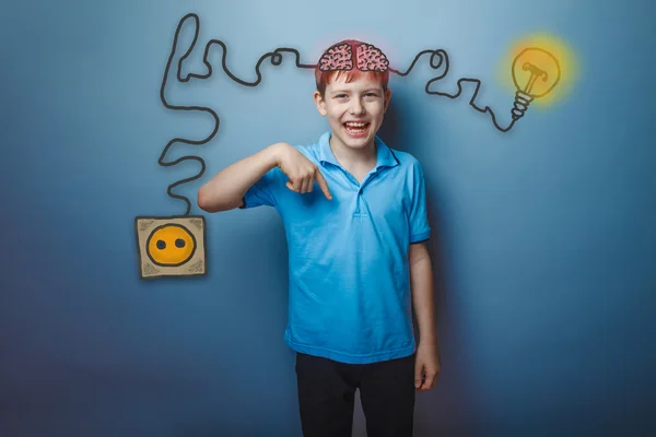 Teenage boy laughing and showing his finger down the charging co — Stock fotografie