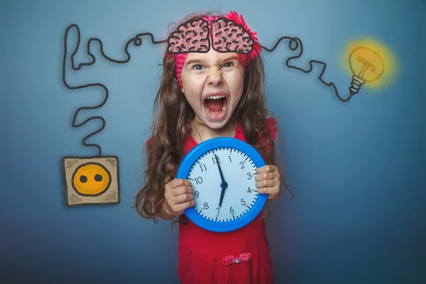 Teenage girl holding a clock and cries of rage charging cord plu — Φωτογραφία Αρχείου