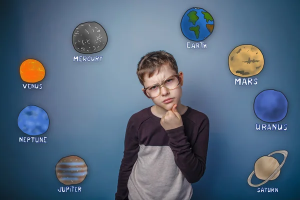 Teenage boy in glasses thinking planets of the solar system astr — Zdjęcie stockowe