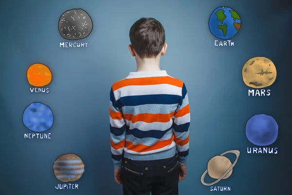 Teenager boy turned his back on the planets of the solar system — Stock Fotó