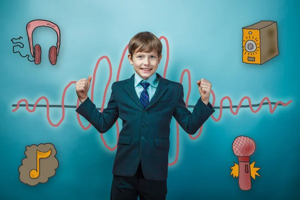 Teenage boy in a business suit laughs and shows the strength of — Stockfoto