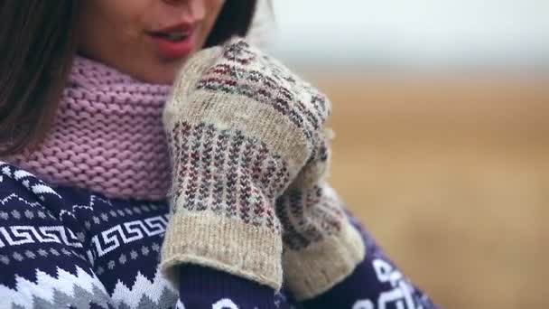 Woman girl portrait in sweater scarf and mittens on nature autumn dry grass cold — Stock Video