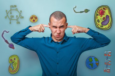 Male from in a blue shirt fingers plugged ears want to hear a se