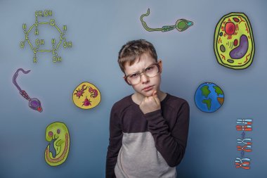 Teenage boy in glasses holding his chin tilted his head deep in
