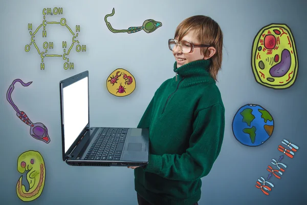 Teenage boy in glasses holding a laptop in hands and laughs icon — 图库照片