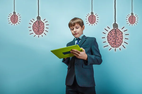 Adolescent boy official style works on the tablet brain bulb cre — Stock Photo, Image