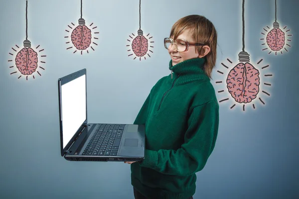 Adolescent boy in glasses laughing and holding a notebook brain Zdjęcia Stockowe bez tantiem