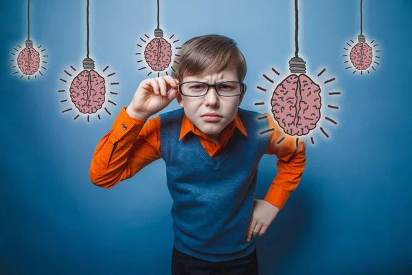Adolescent boy holds hand glasses leaned forward peering brain b — Zdjęcie stockowe