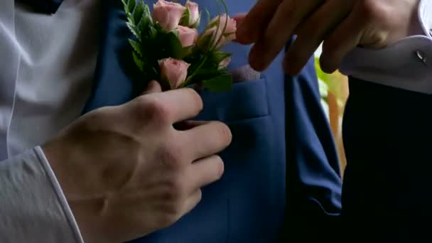 Groom boutonniere on man corrects his pocket hand — Stock Video