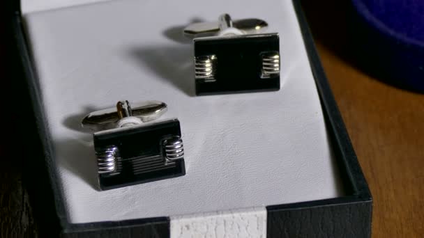 Les boutons de manchette sont dans la boîte sur la table 