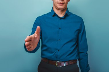 a man can not see the person  pulls a hand shake on a gray  back