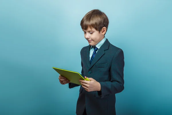 Teen  boy of twelve European  appearance in a business suit hold — Zdjęcie stockowe