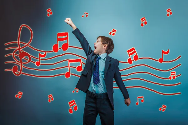 A teenager boy raised his hand up business style of music notes — Zdjęcie stockowe