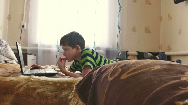 Boy is playing laptop internet browsing — Stock Video