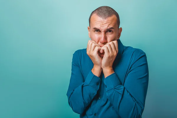 A  man of European appearance thirty years chewing fingernails o — Stock Photo, Image