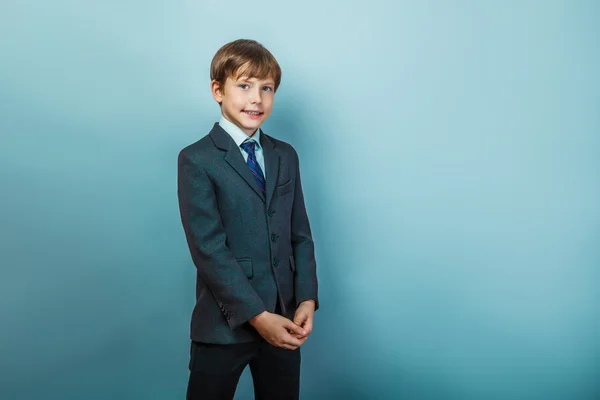 A boy of twelve European appearance  in a suit is smiling portra — Stock Photo, Image