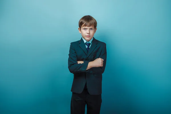 Teen boy of twelve European appearance in a business suit crosse — Stock fotografie