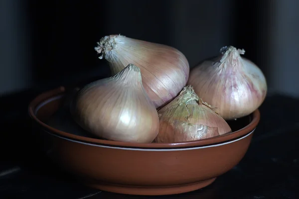 Cibule v misce na stůl — Stock fotografie