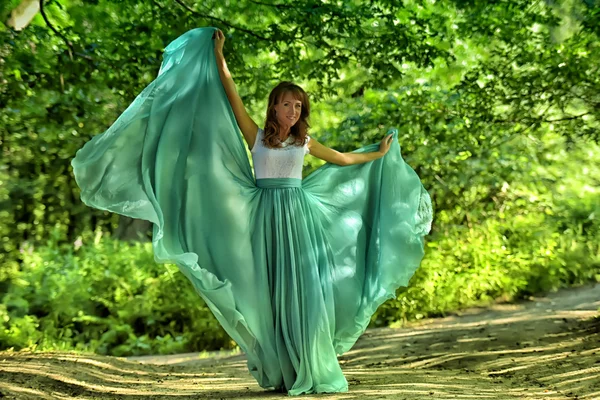 Beauty woman with dress flying Stock Picture