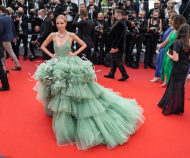 CANNES, FRANCE - JULY 07, 2021: German fashion influencer Leonie Hanne poses in a green fairy dress as she arrives for the screening of the film 