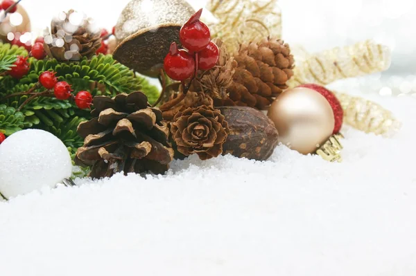 Christmas decorations nestled in snow — Stock Photo, Image