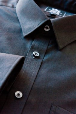 Dark men's shirts show the collar, cuffs, placket, buttons, and parts of the pocket. clipart