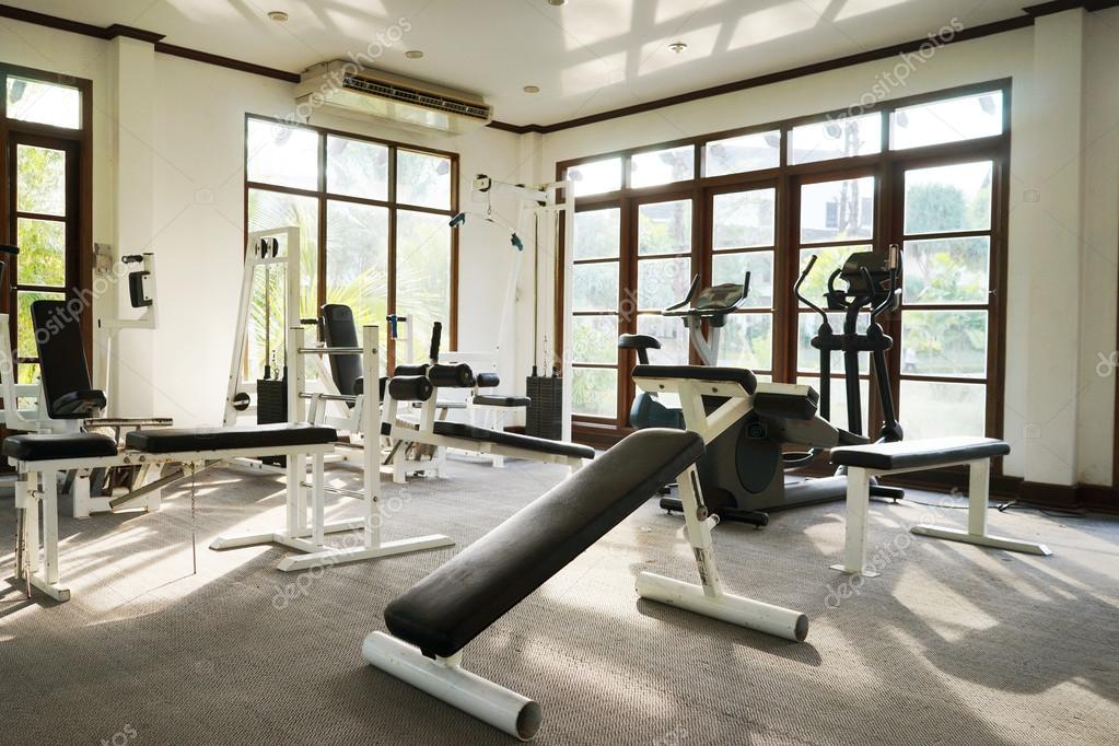 Interior of the old gym equipment in the evening Stock Photo by