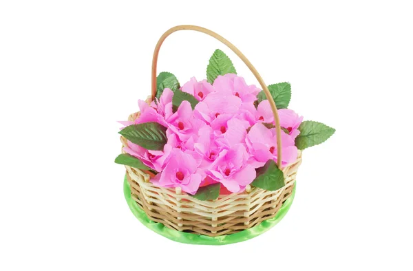 Beautiful wattled basket with artificial flowers — Stock Photo, Image