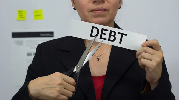 Üzletasszony darabok adósságok koncepciójának — Stock Fotó
