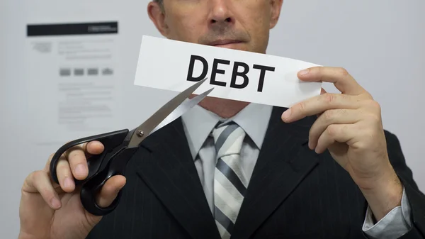 Üzletember darabok adósságok koncepciójának — Stock Fotó