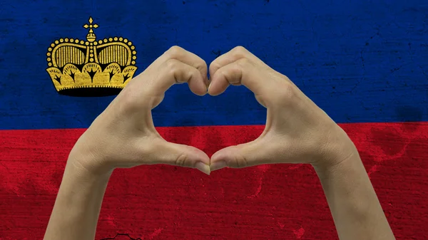 Händer hjärtat Symbol Liechtensteins flagga — Stockfoto