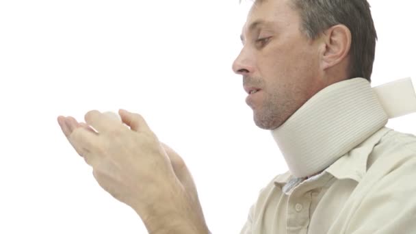 Male In Neck Support Brace Taking Pills — Stock Footage Male In Neck Support Brace Taking Pills Stock Footage