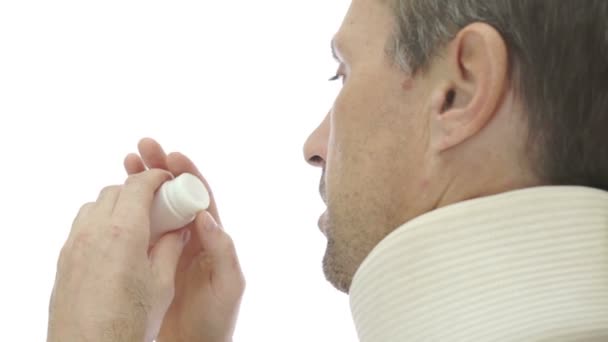 Male In Neck Brace Over the Shoulder Pills — Stock Footage Male In Neck Brace Over the Shoulder Pills Royalty Free Stock Video