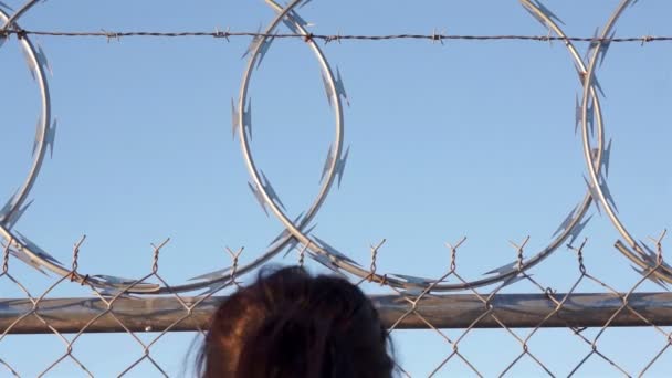 Woman Climing Razor Wire Fence — Stock Video