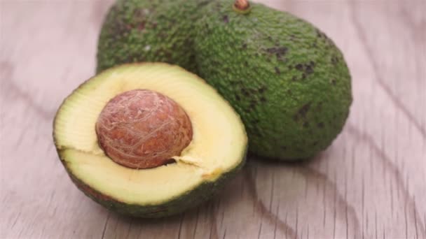 Half and Whole Avocados on Wood Dolly — Stock Video