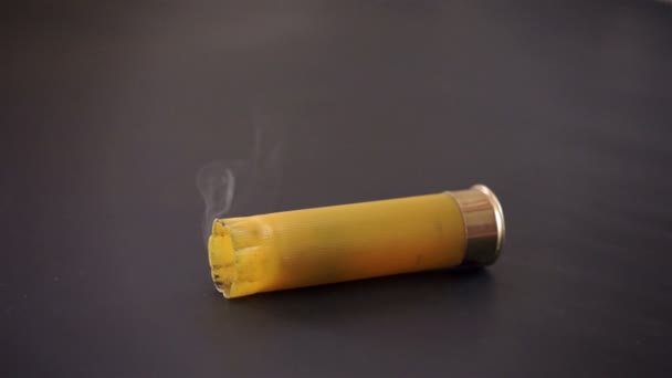 Shotgun Shell Falling and Smoking — Stock Video